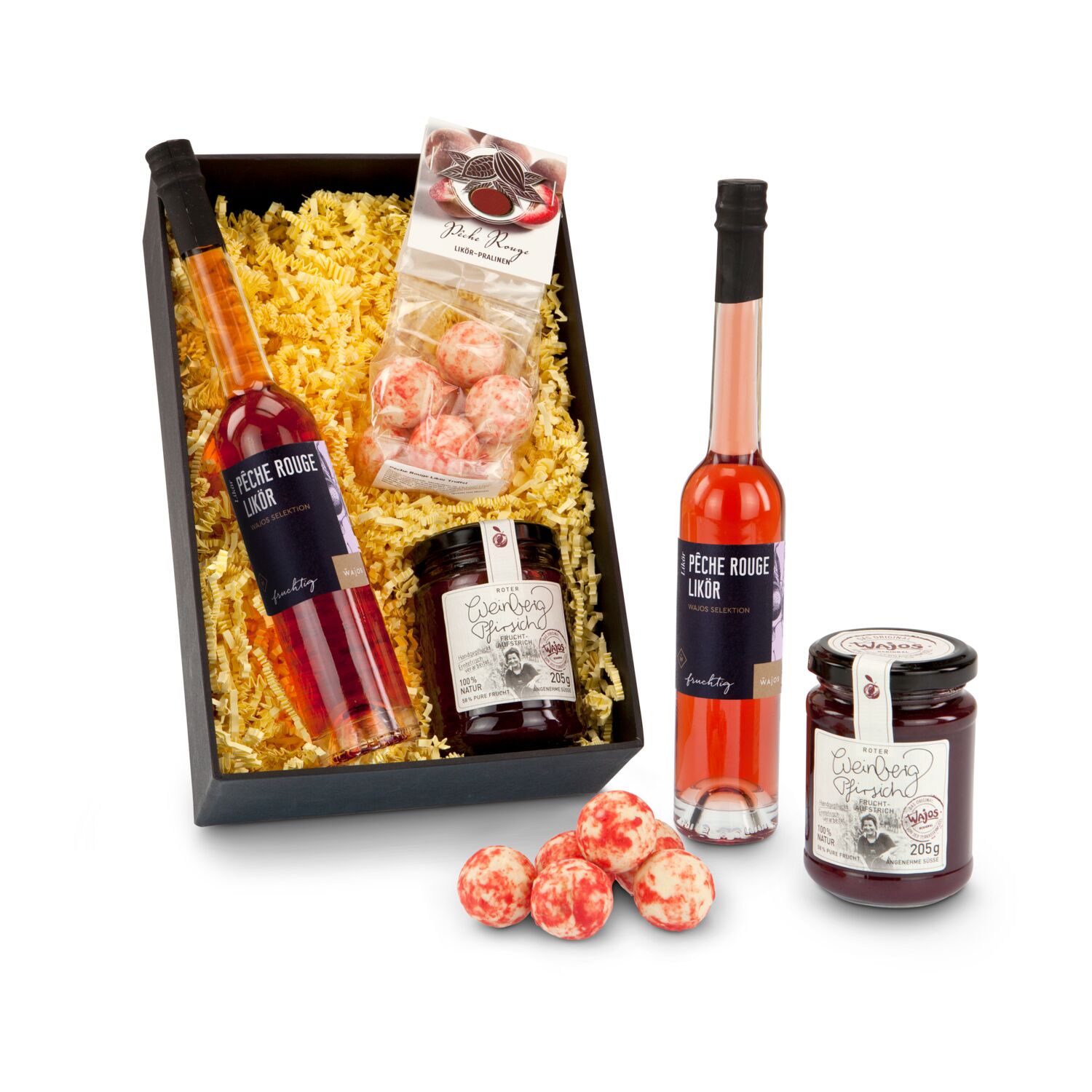 Eine exklusive Frucht: 100 ml Liqueur Pêche Rouge, 75 g Pêche Rouge Liqueur-Pralinen und 205 g Weinbergpfirsich Fruchtaufstrich im Glas.