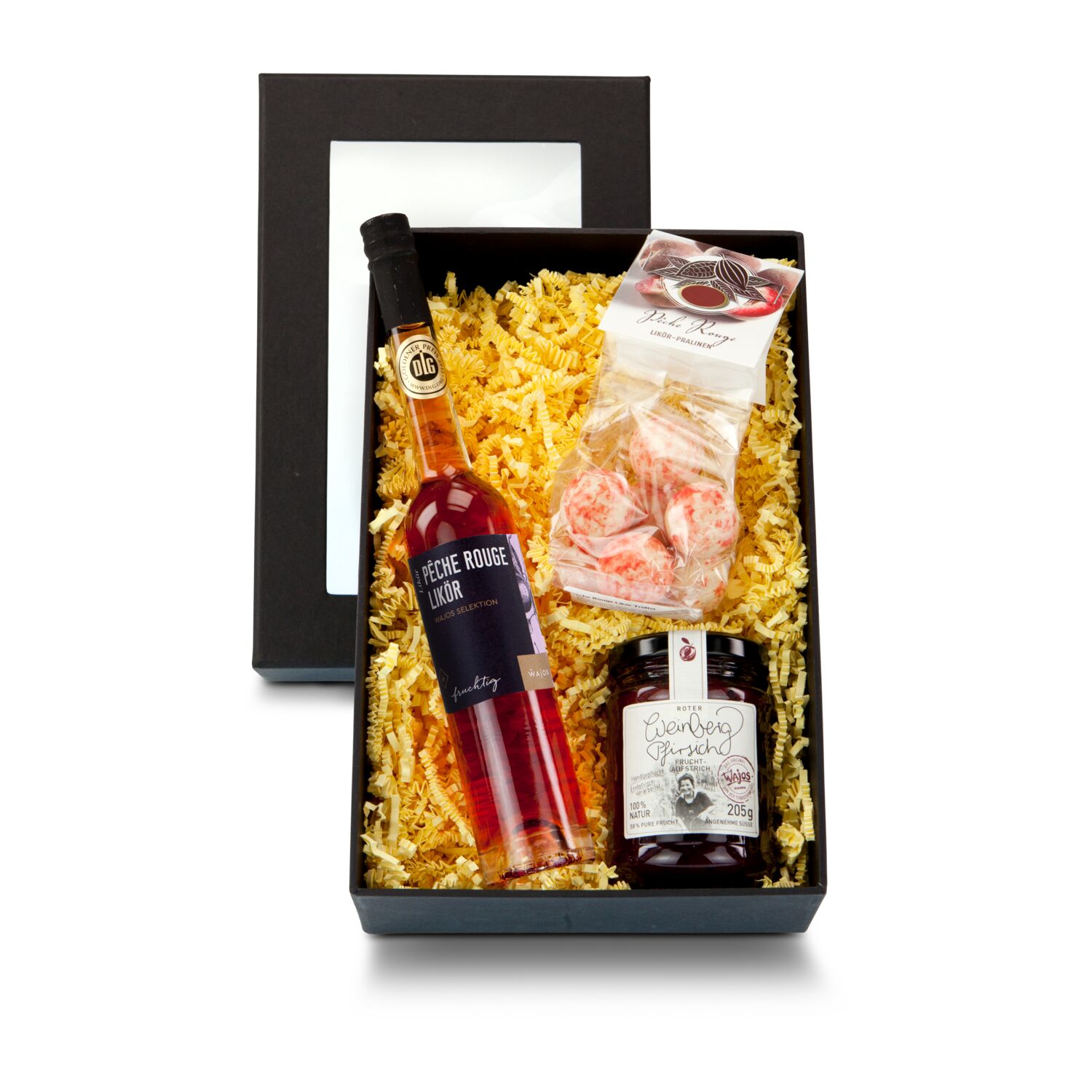 Eine exklusive Frucht: 100 ml Liqueur Pêche Rouge, 75 g Pêche Rouge Liqueur-Pralinen und 205 g Weinbergpfirsich Fruchtaufstrich im Glas.