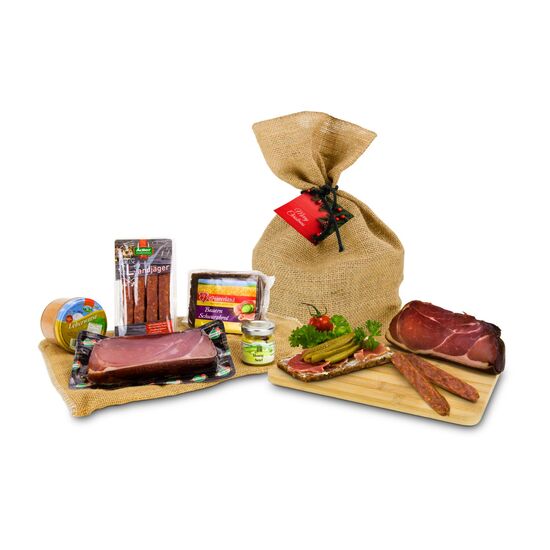 Schwarzwälder Schinken, 1 Glas Leberwurst, 4 Landjäger, dazu Senf und Vollkornbrot verpackt im Jutesack mit weihnachtlichem Anhänger.
