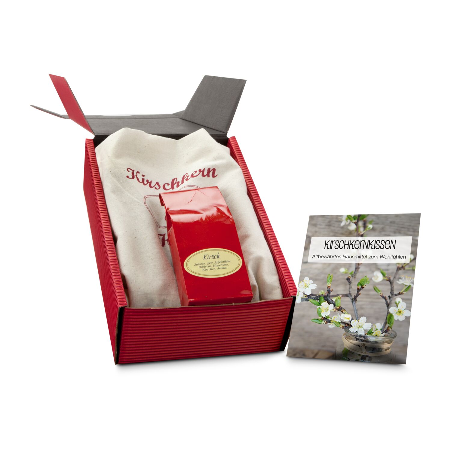 Wohlfühlen und entspannen bei einer Tasse Kirschtee und einem warmen Kirschkernkissen. Tee und Kissen kommen in einer roten Geschenkbox.