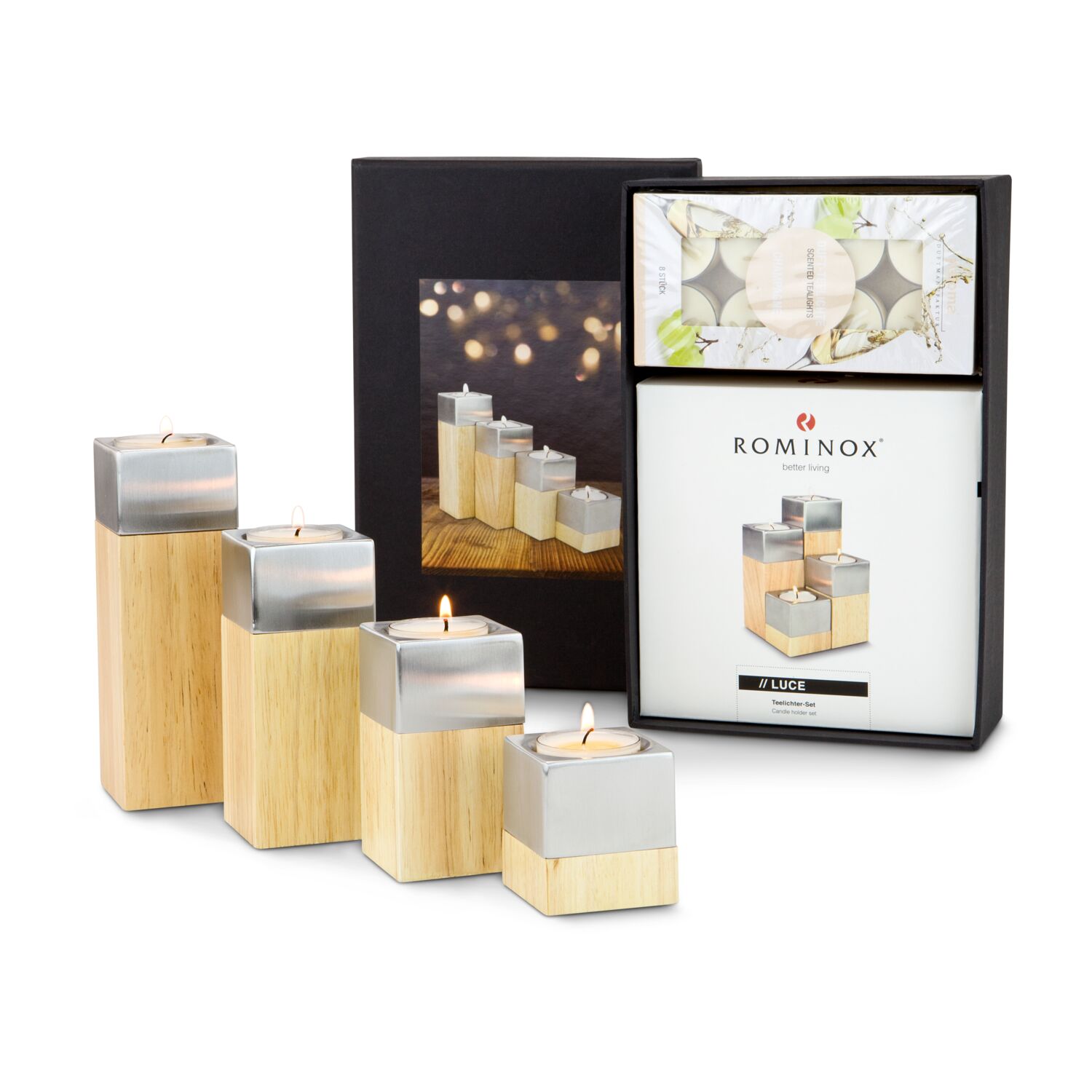 Ein ROMINOX® Kerzen-Quartett mit vier unterschiedlich hohen Holz-Edelstahlquader und 8 edle Duftkerzen Teelichter mit Champagner-Duft.