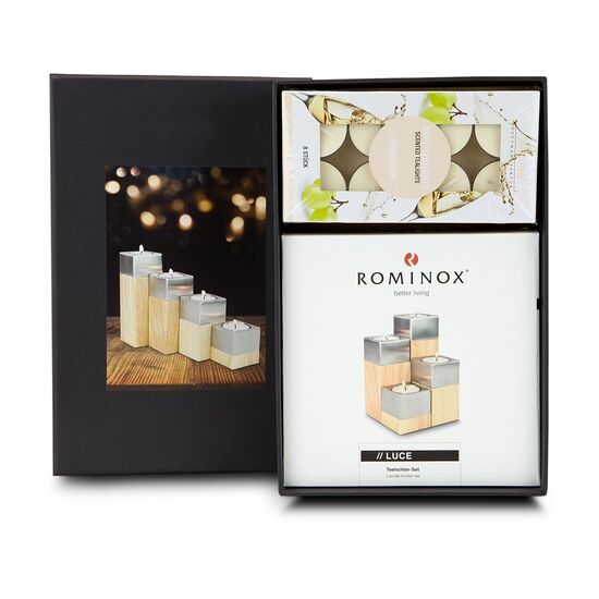Ein ROMINOX® Kerzen-Quartett mit vier unterschiedlich hohen Holz-Edelstahlquader und 8 edle Duftkerzen Teelichter mit Champagner-Duft.