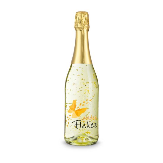 Klare Flasche mit Goldflockentraum (0,75 l) mit Druck „Gold Edition“, gebettet auf schwarzem Sizzle im goldenen Karton.