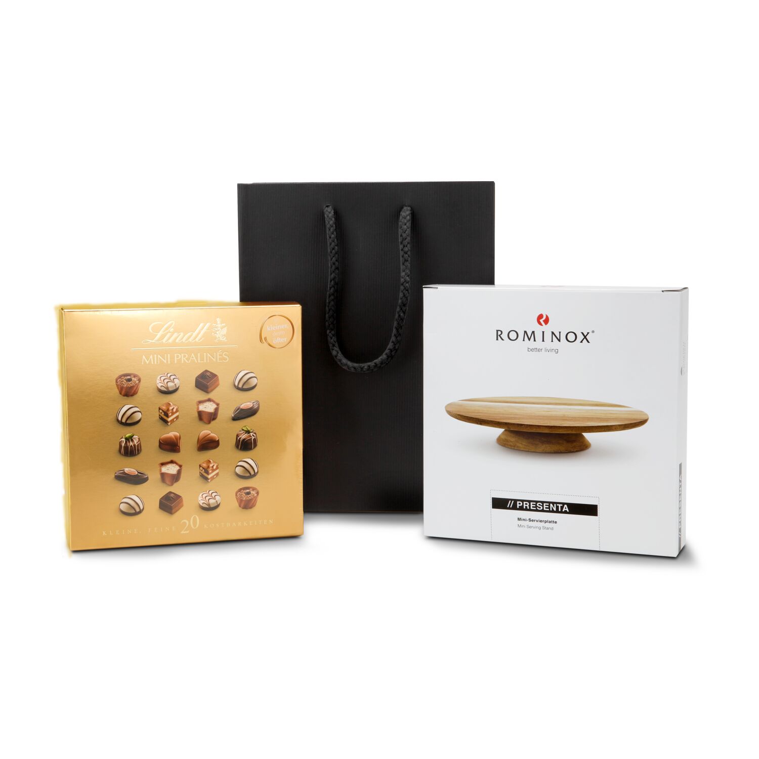 ROMINOX® Mini-Servierplatte Presenta und passend dazu eine Packung Lindt Mini-Pralinés verpackt in einer schwarzen Geschenktüte.